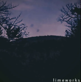 A low quality picture of a mountain with some trees in the foreground with a purple filter